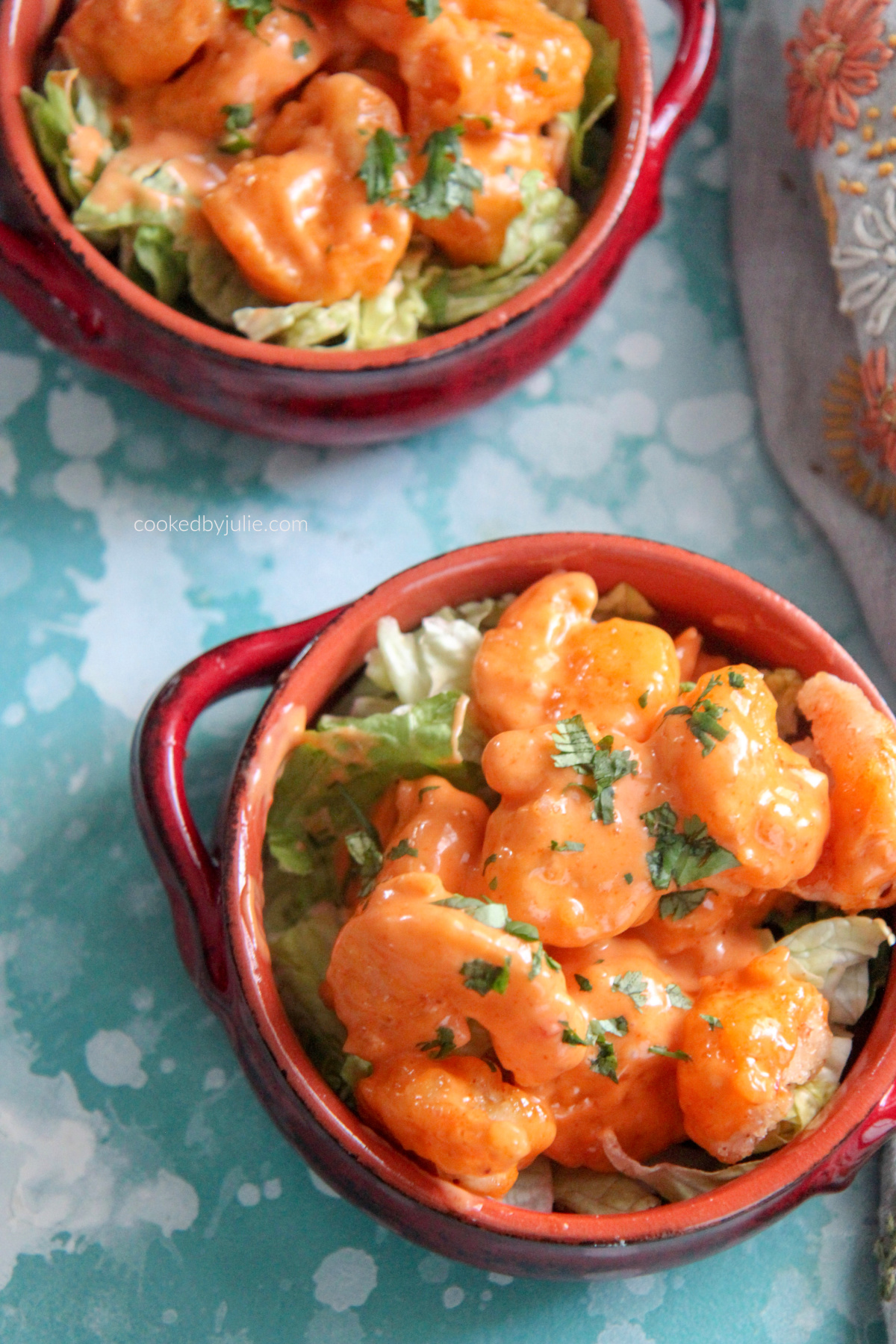 fried shrimp coated in mayo based dressing with fresh parsley on top