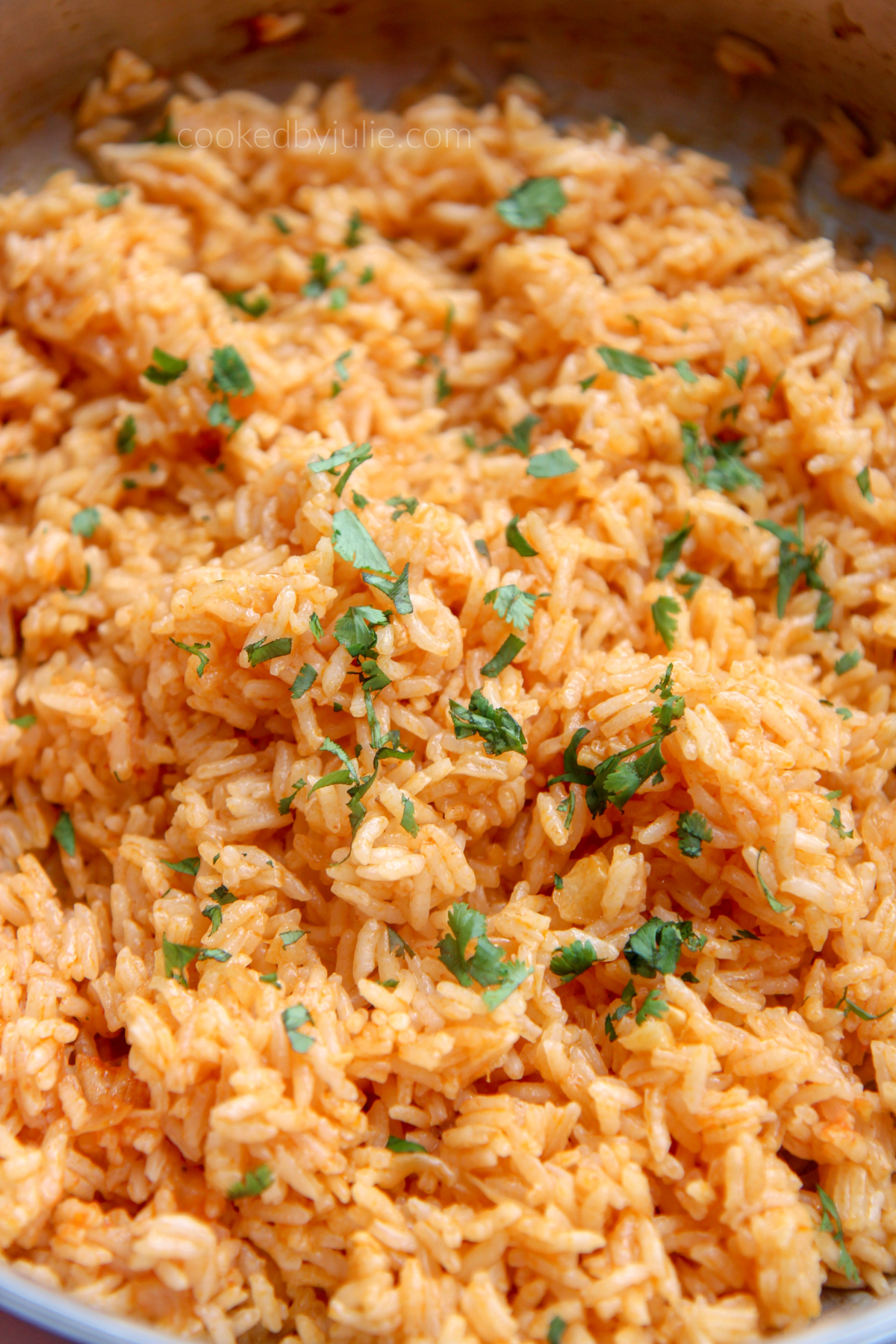 a large serving of Spanish rice and fresh cilantro 