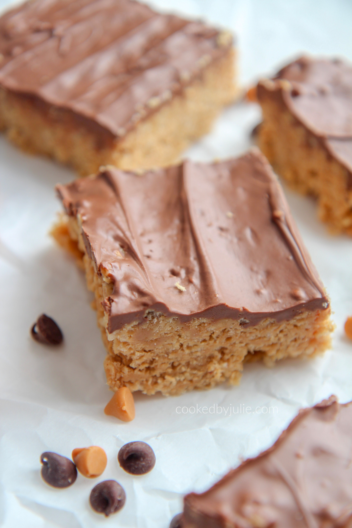 scotcharoos on parchment paper with chocolate chips and butterscotch chips