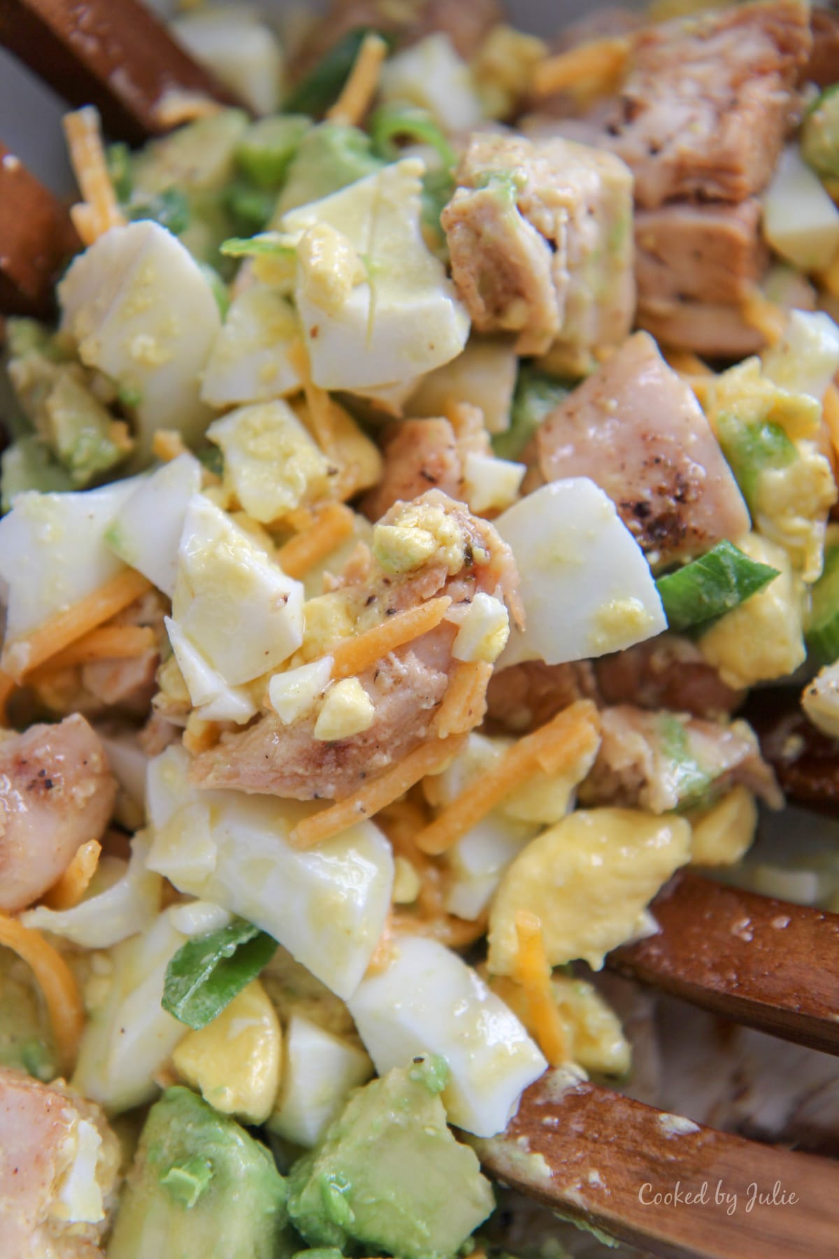 eggs, avocados, cheese, chicken, and scallions tossed in a lemon vinaigrette