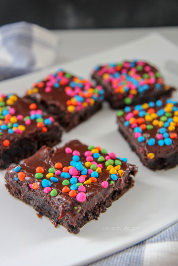 brownies with rainbow chips on top of a white plate