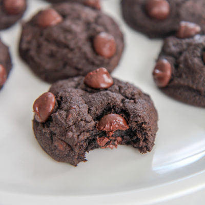 chocolate cookie bitten into on a white plate