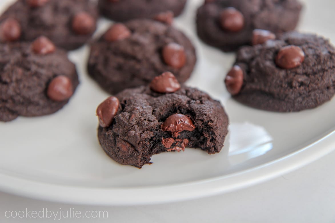 double chocolate cookies up close on a white plate 