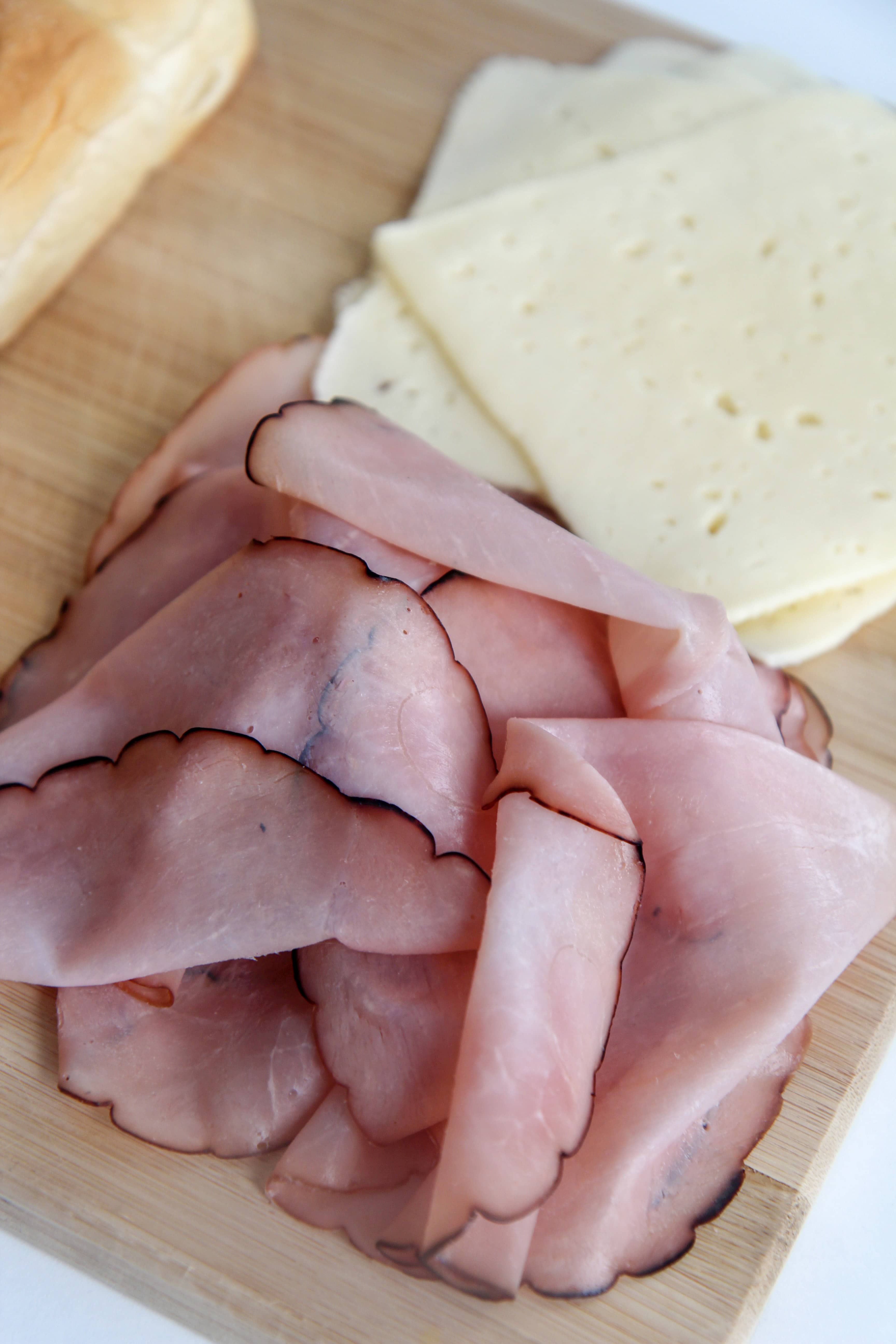 deli ham and cheese on a wooden board 