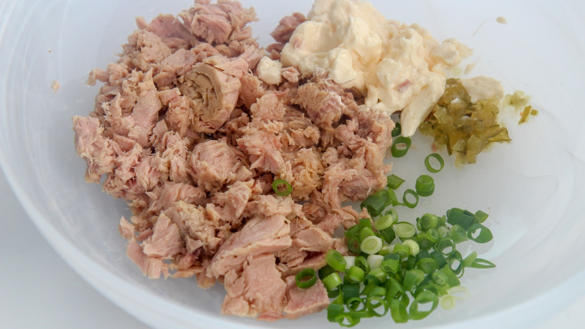 canned tuna, scallions, mayo, and sweet relish in a white bowl 