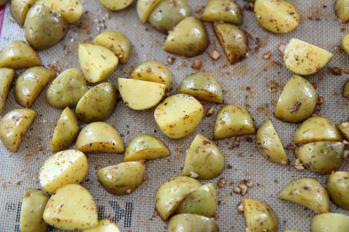 seasoned yellow baby potatoes on a baking sheet