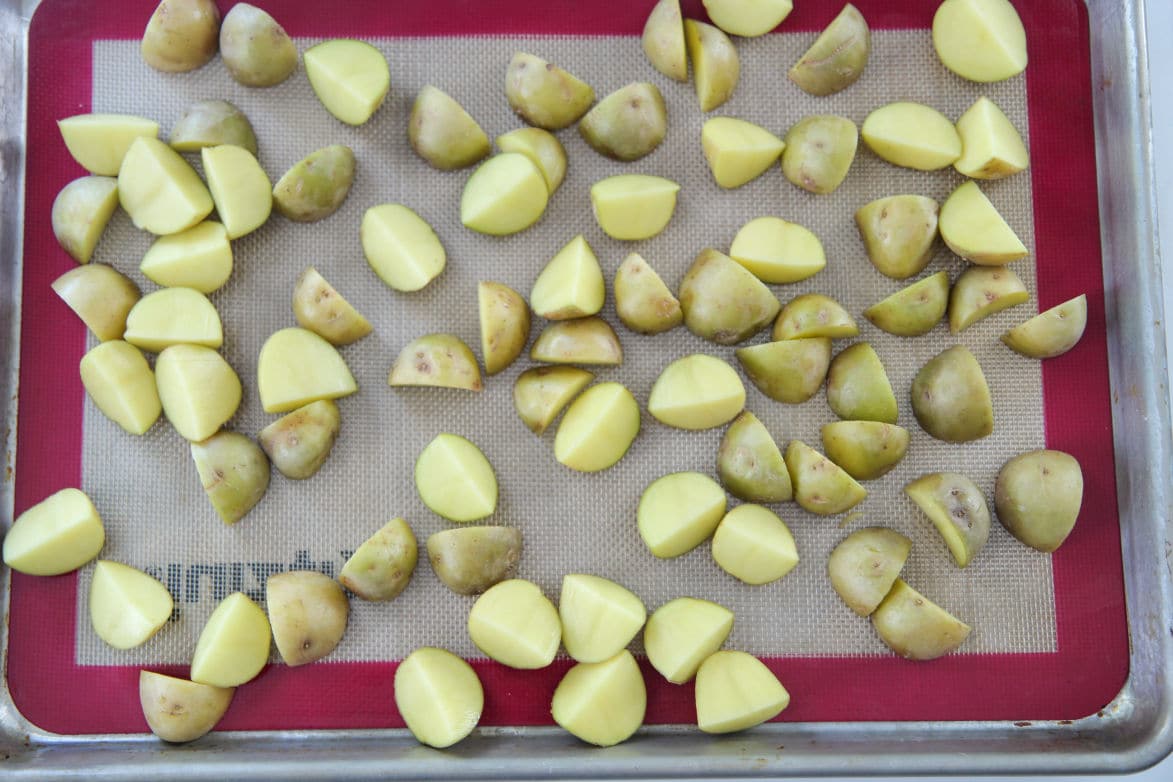 yellow baby potatoes on a baking sheet 