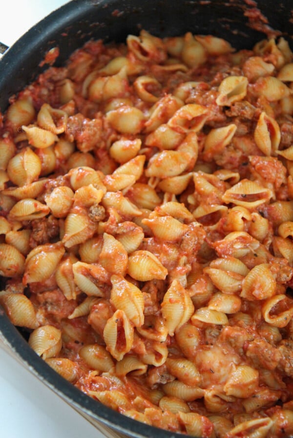 beef and shells in a large black skillet