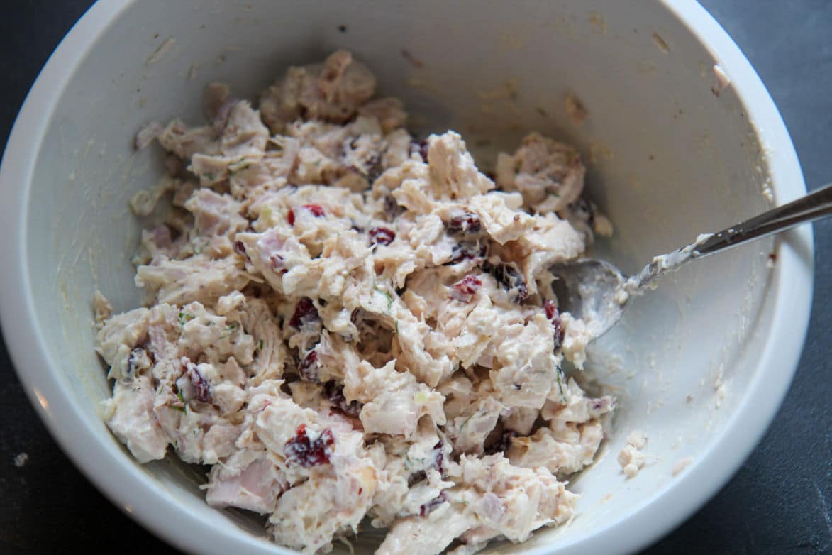 salad in a white bowl with a spoon