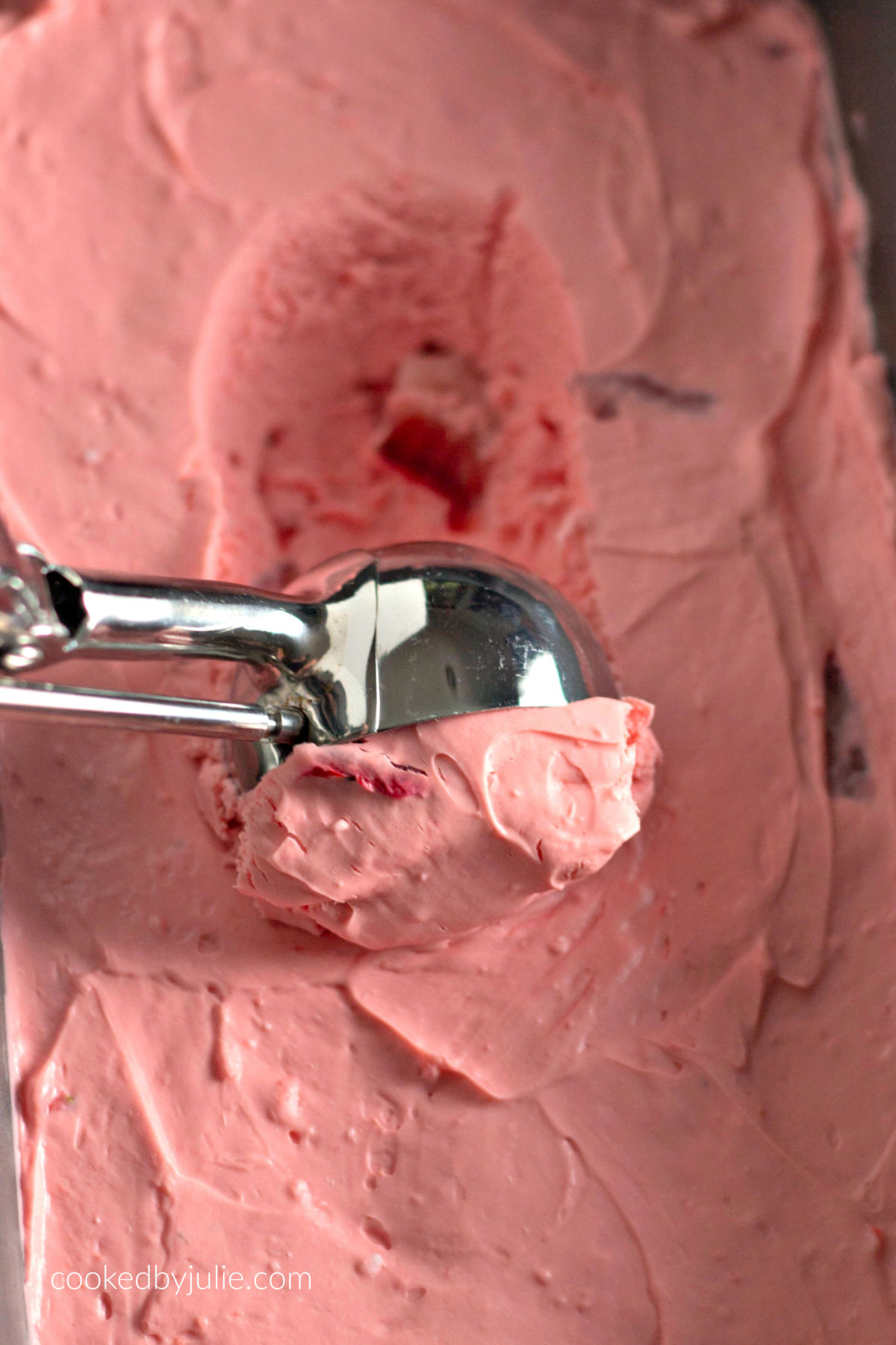 strawberry fat bomb in a bread pan with an ice cream scoop