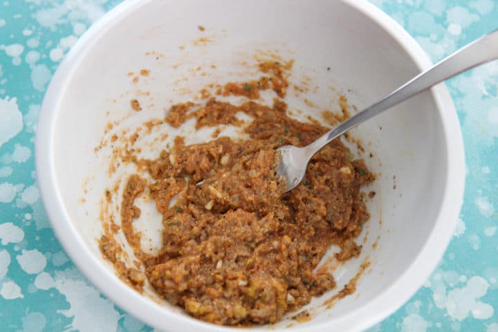 turkey meatloaf ingredients mixed in a white bowl with a fork 