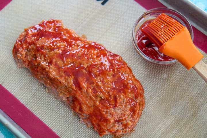 turkey meatloaf with a ketchup glaze on a baking sheet 