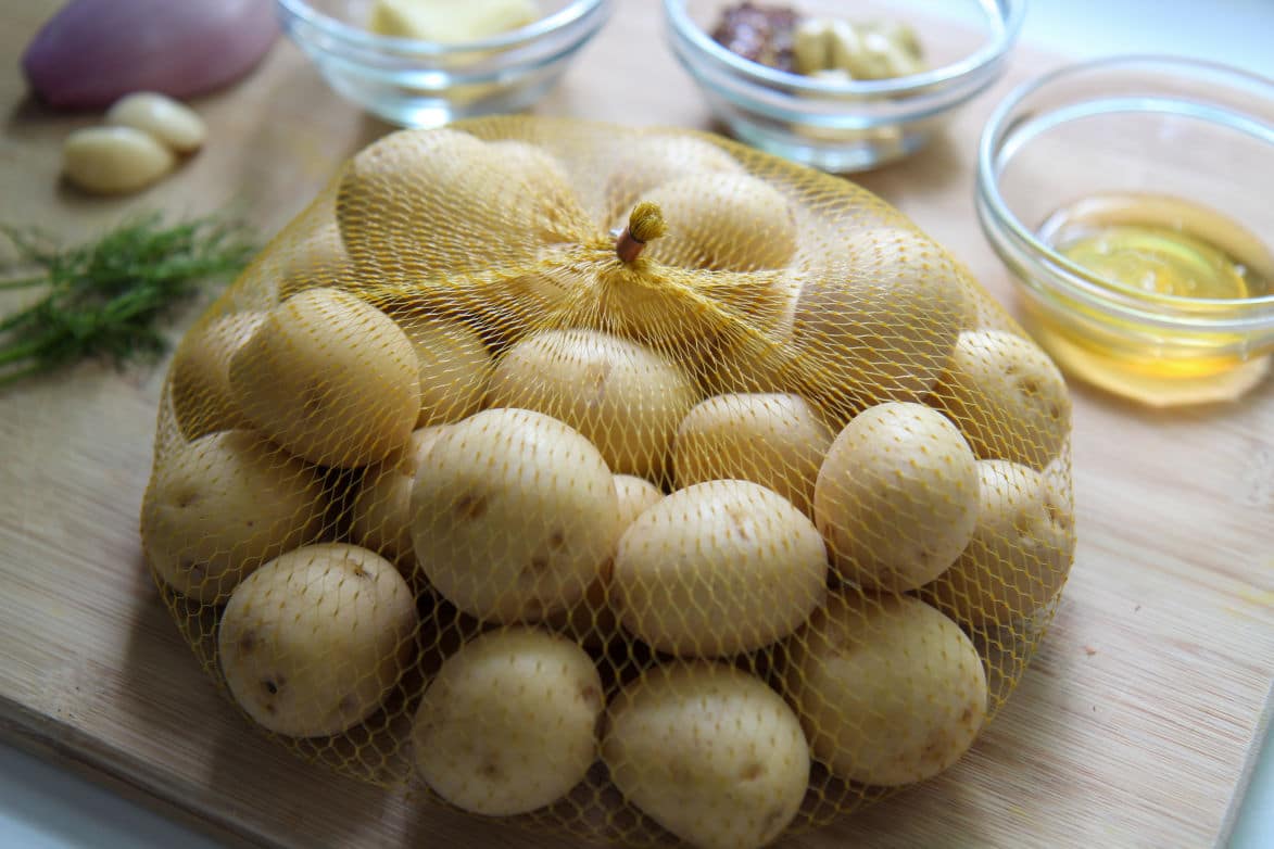 baby yellow potatoes in a bag with other ingredients in the background