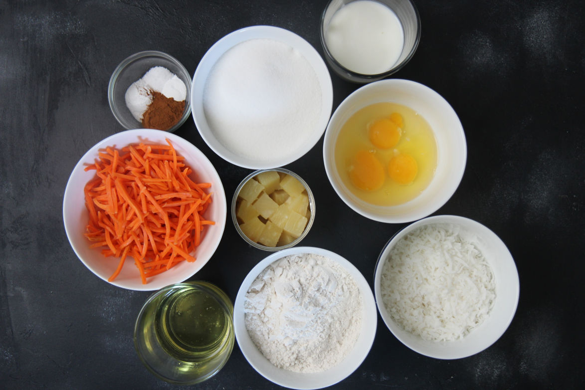 nine small bowls with ingredients on a black surface 