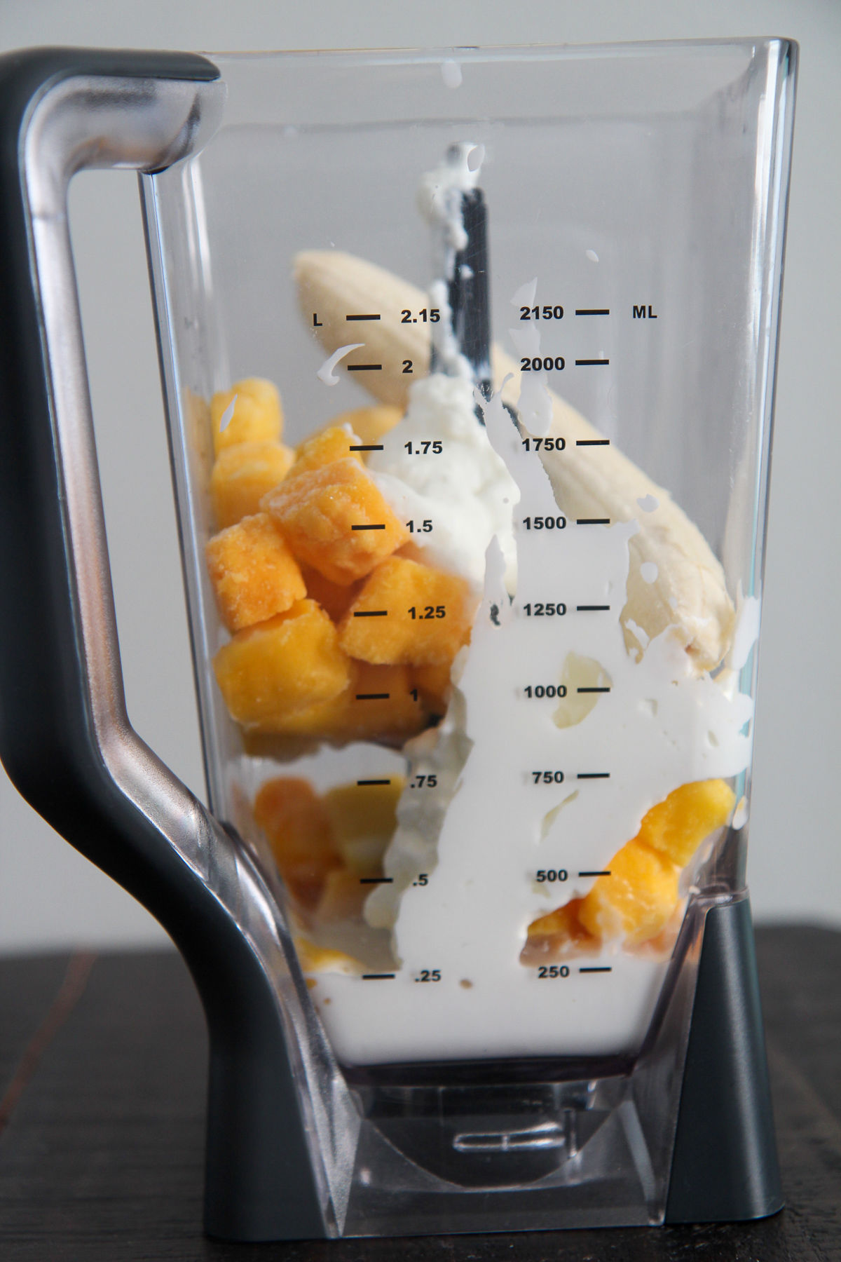 frozen mangoes, milk, yogurt, and banana in a ninja blender.