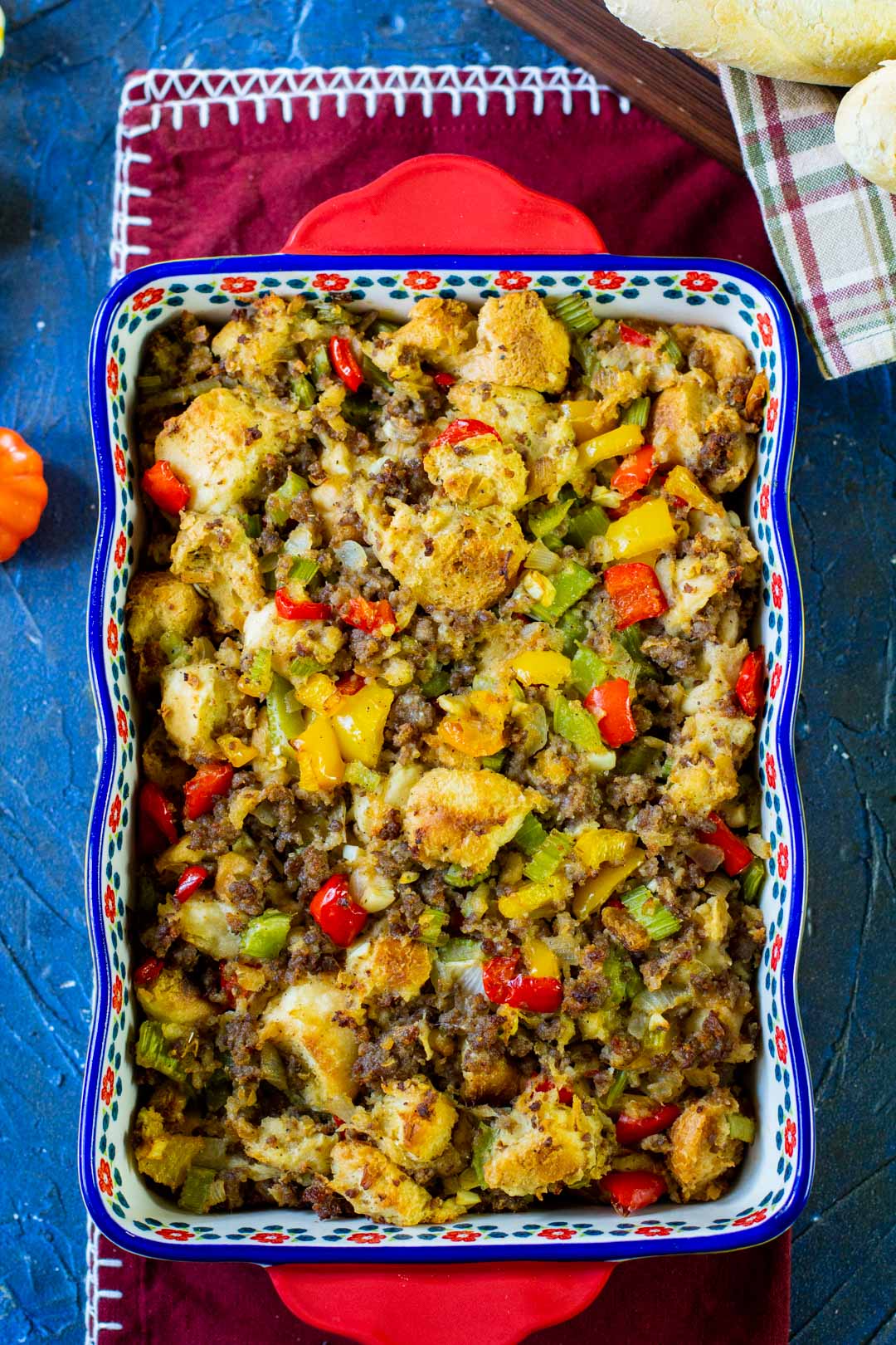 sausage stuffing in a blue and red casserole dish 
