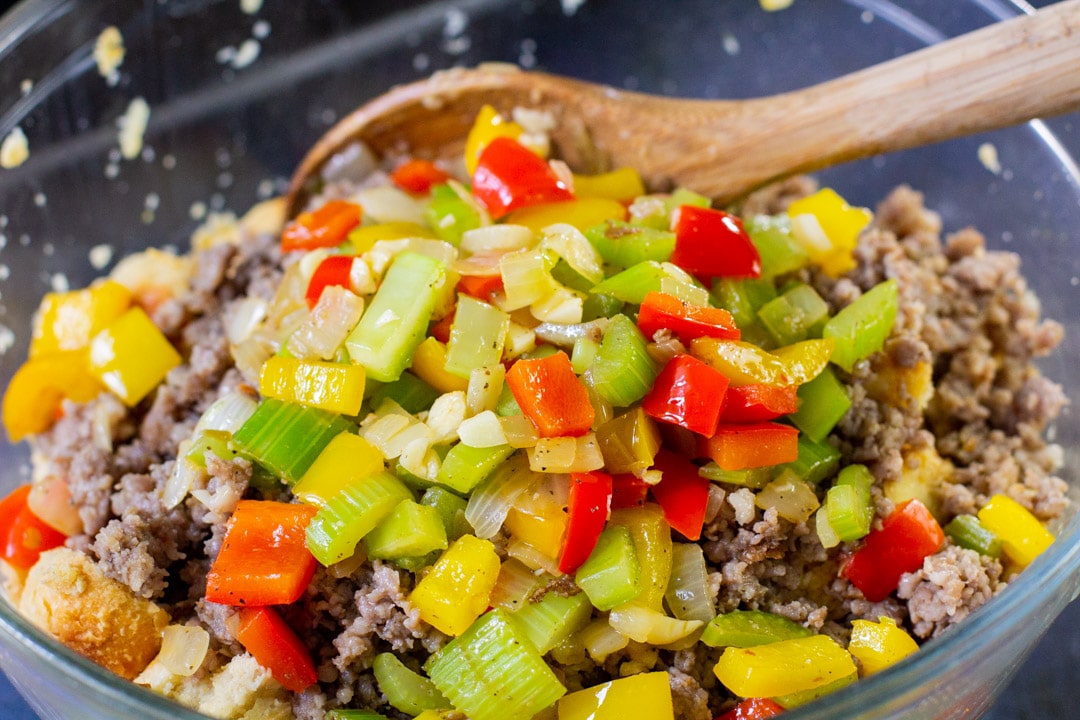 stuffing mixture in a glass bowl with a wooden spoon 