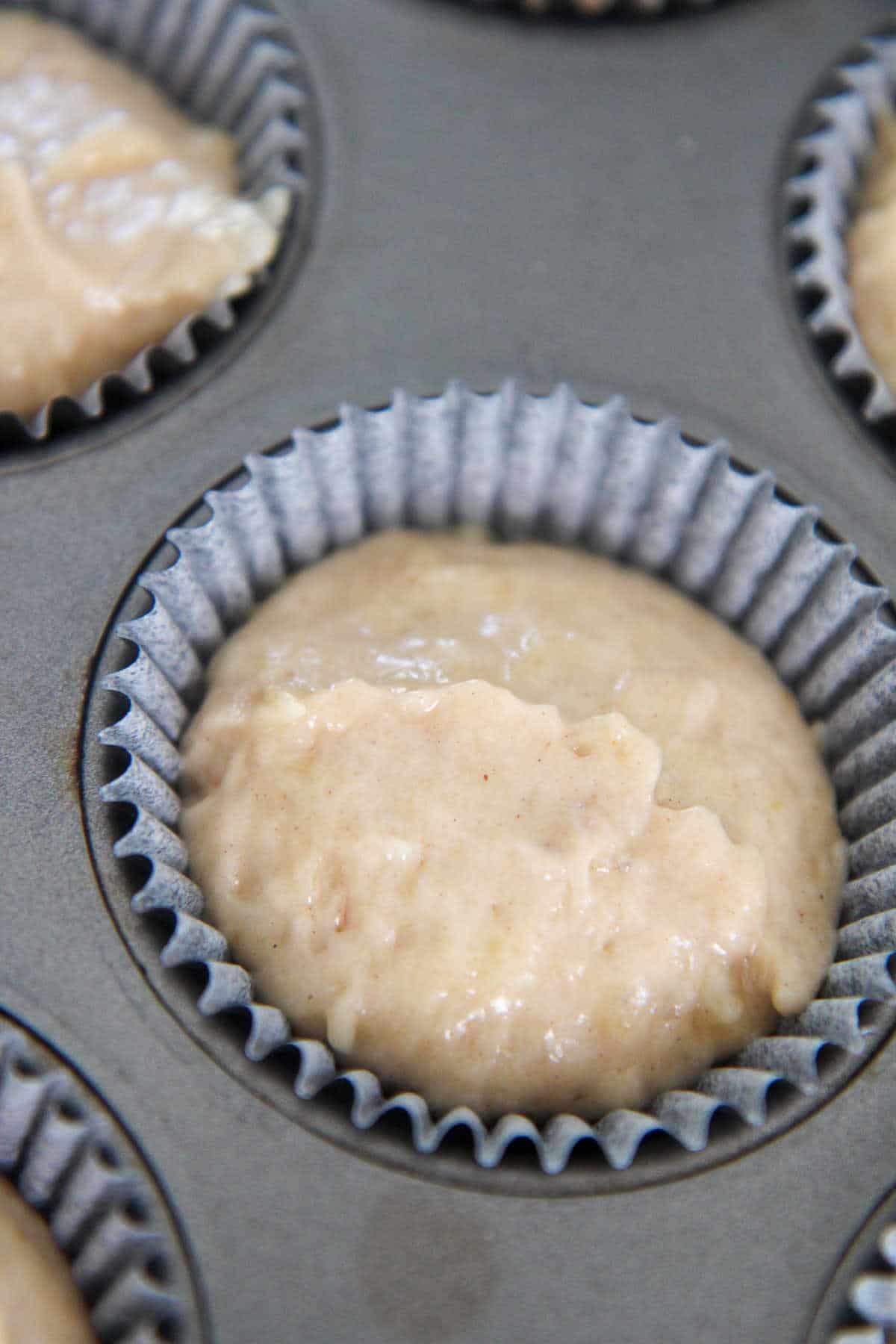 banana muffin batter in a cupcake liner 