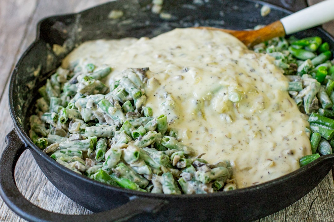 frozen green beans and cream sauce in black skillet 