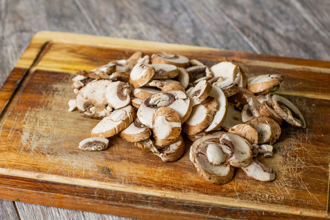 sliced mushrooms on a wooden board 