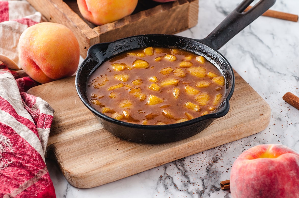 peach compote in a black iron skillet