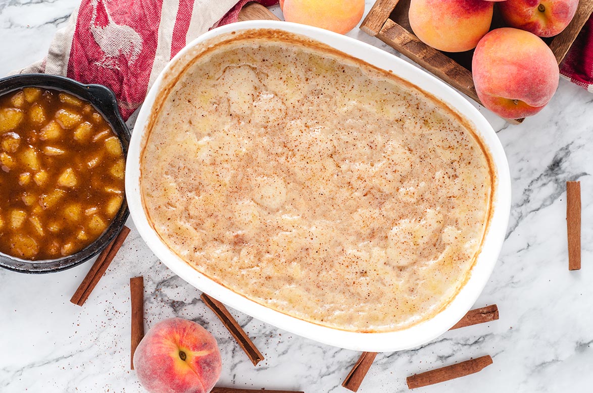 baked rice pudding with cinnamon sticks and peach compote on the side 
