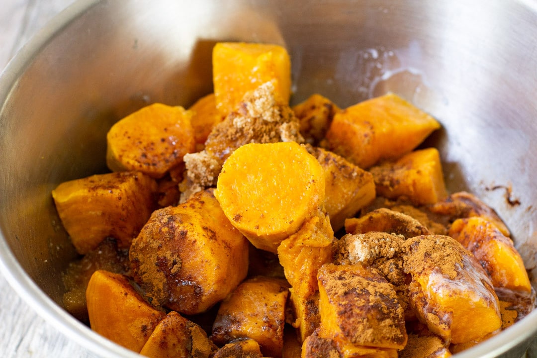 sweet potatoes and spices in a stainless steel bowl