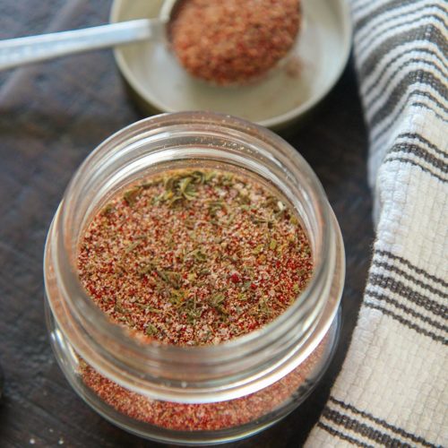 cajun seasoning blend in a small jar with a spoon