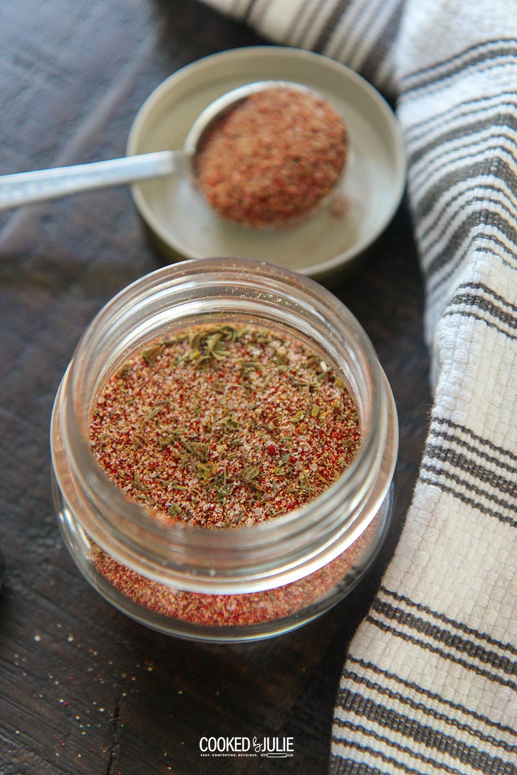 cajun seasoning blend in a small jar with a spoon 