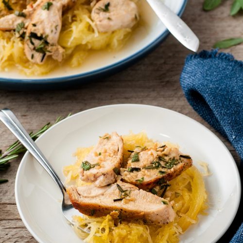 spaghetti squash and sliced chicken in a white bowl