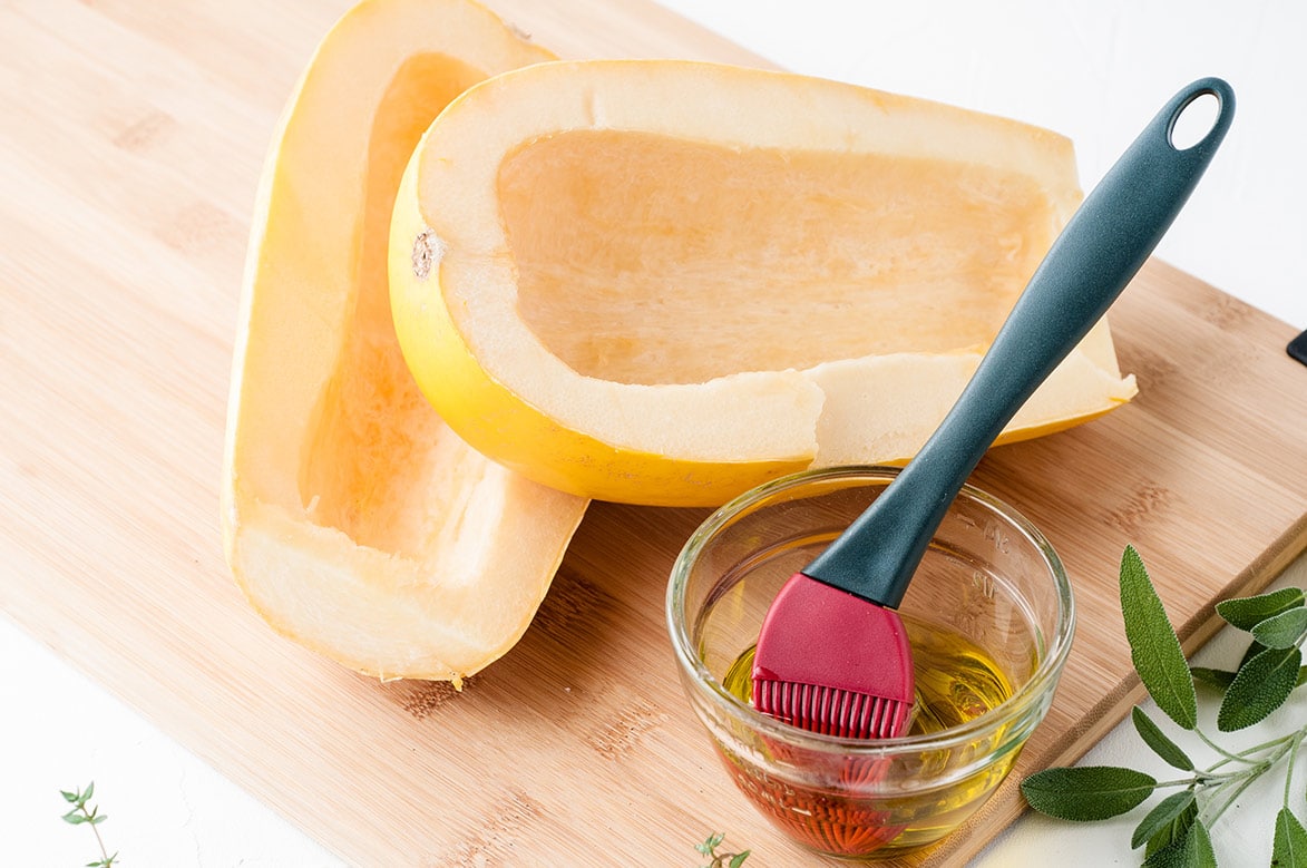 yellow squash on a wooden board with olive oil on the side 