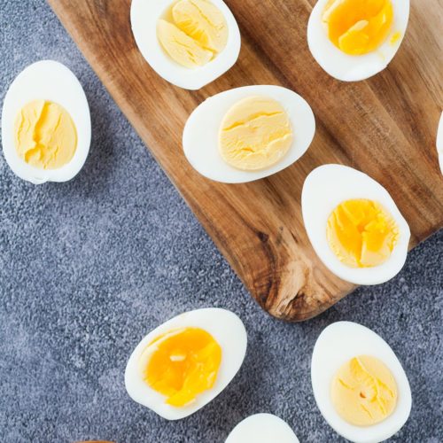 scattered boiled egg halves with a pinch bowl of salt and pepper