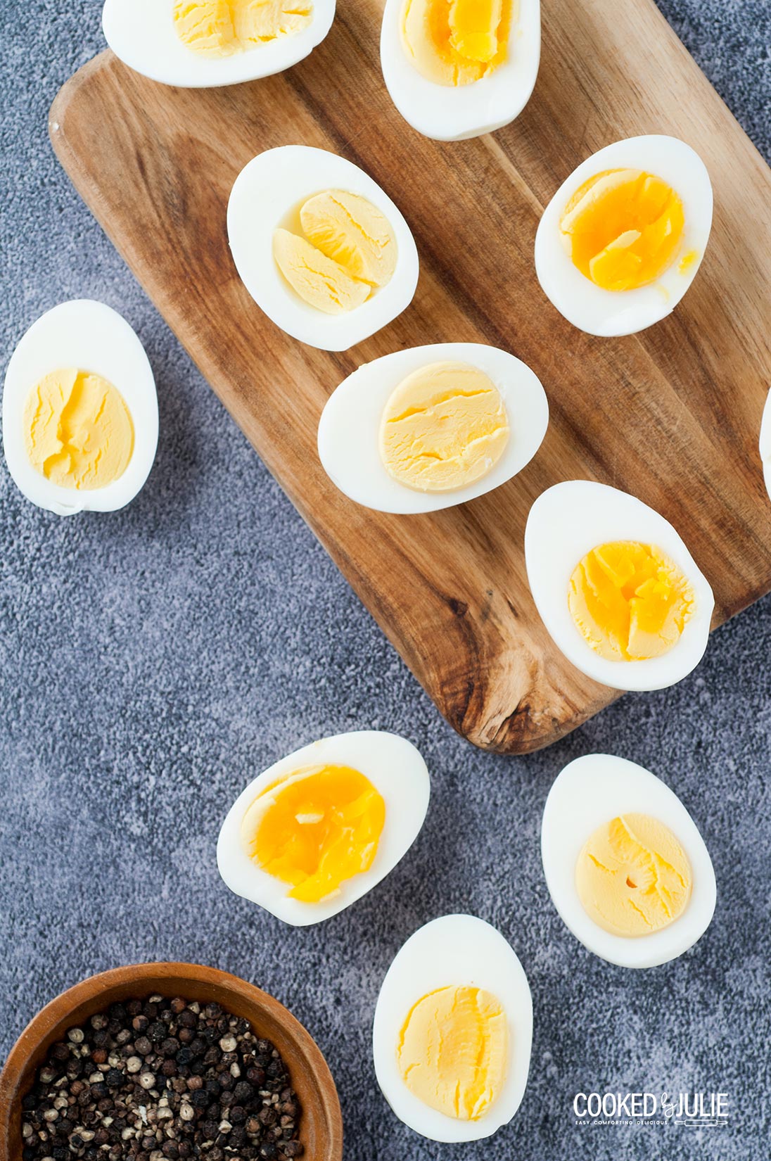 scattered boiled egg halves with a pinch bowl of salt and pepper