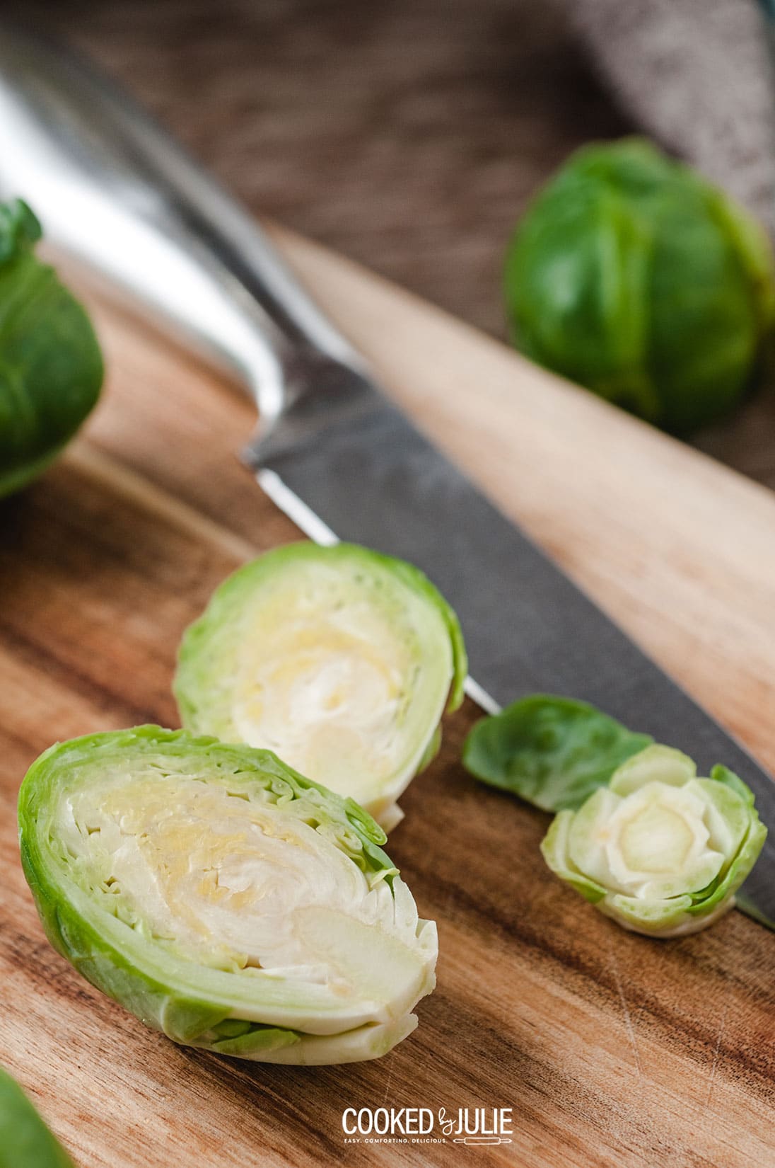 brussel sprouts sliced in half on a wooden board 