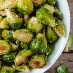 baked brussel spouts in a white bowl