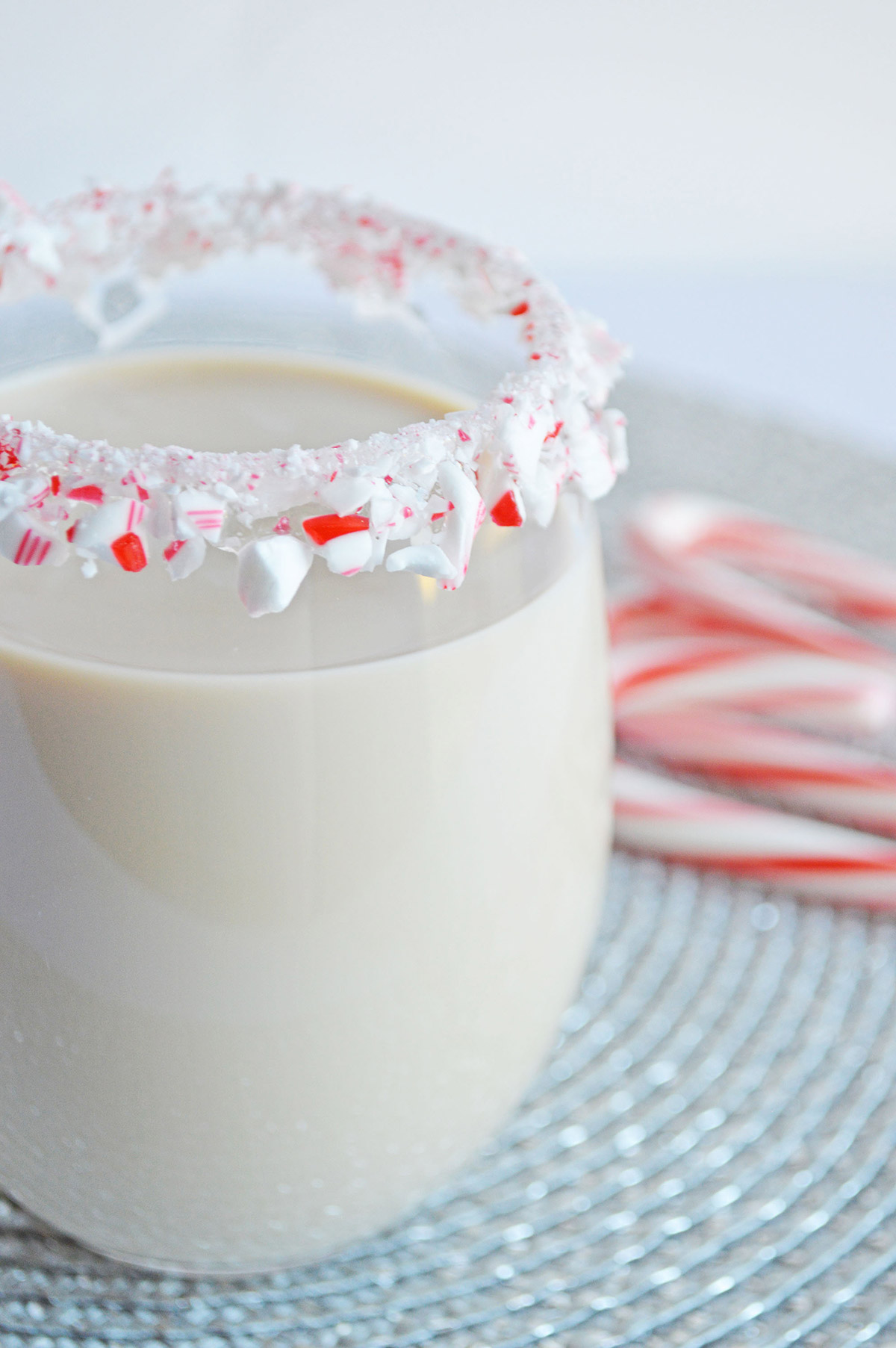 peppermint white Russian in a glass with a candy cane rim 