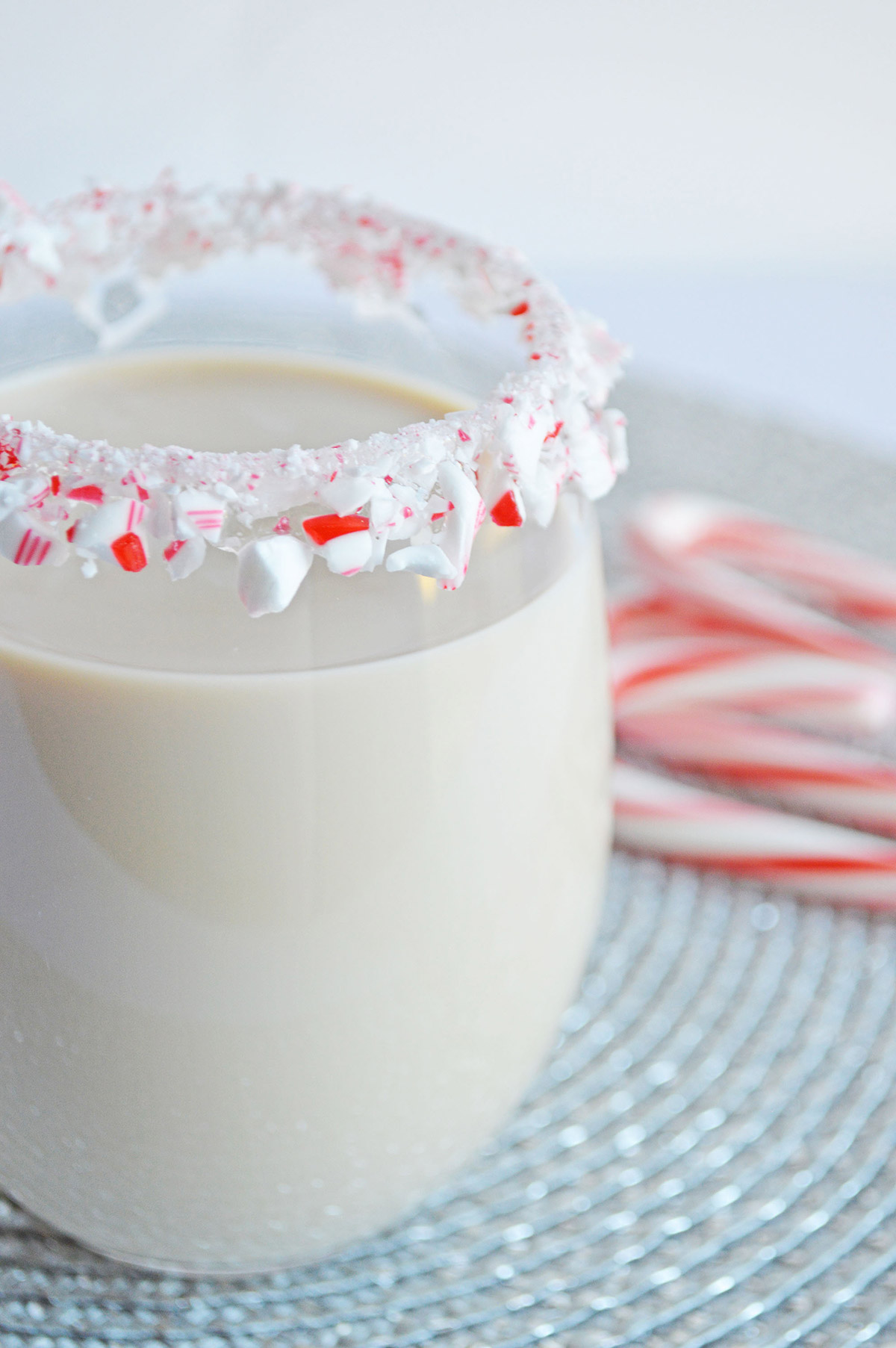 peppermint white Russian in a glass with a candy cane rim