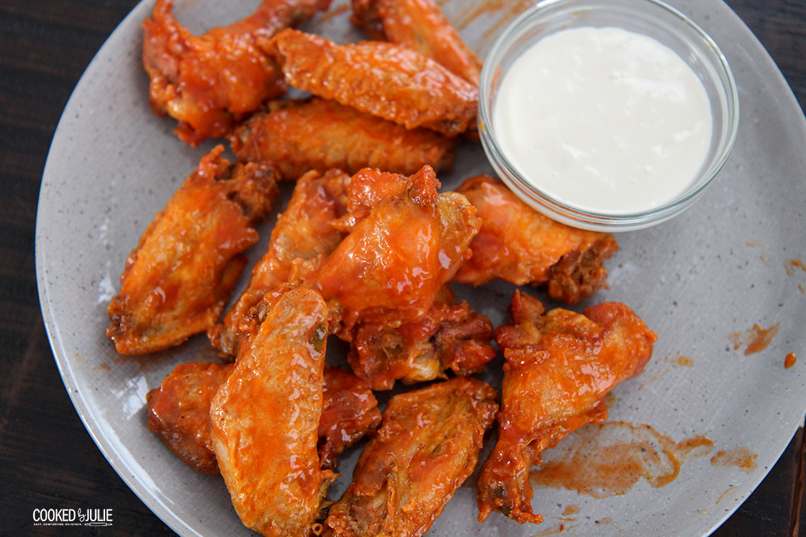 chicken on a gray plate with dip on the side