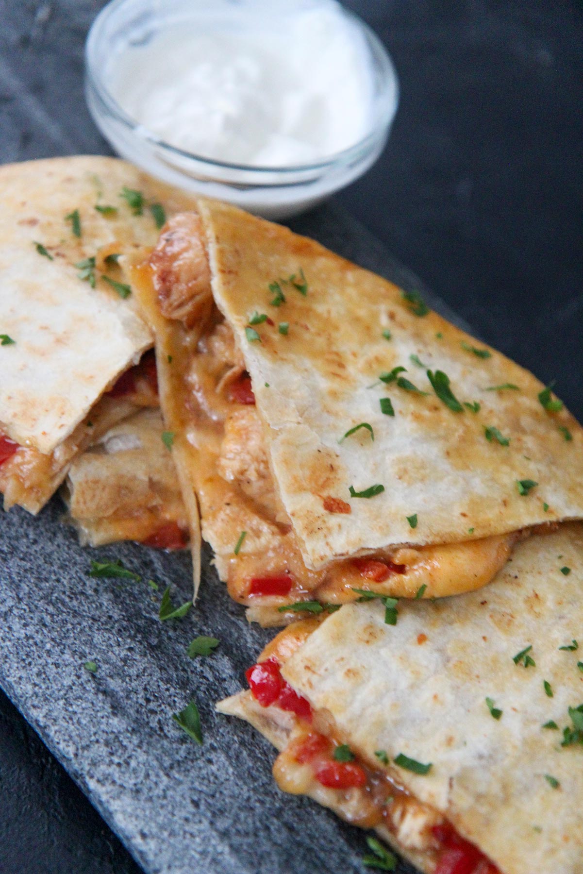 cheese and chicken quesadillas with sour cream on the side 