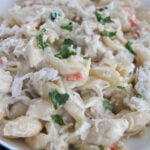 cheesy crab Alfredo pasta in a white bowl