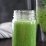 spinach avocado green smoothie in a clear mason jar
