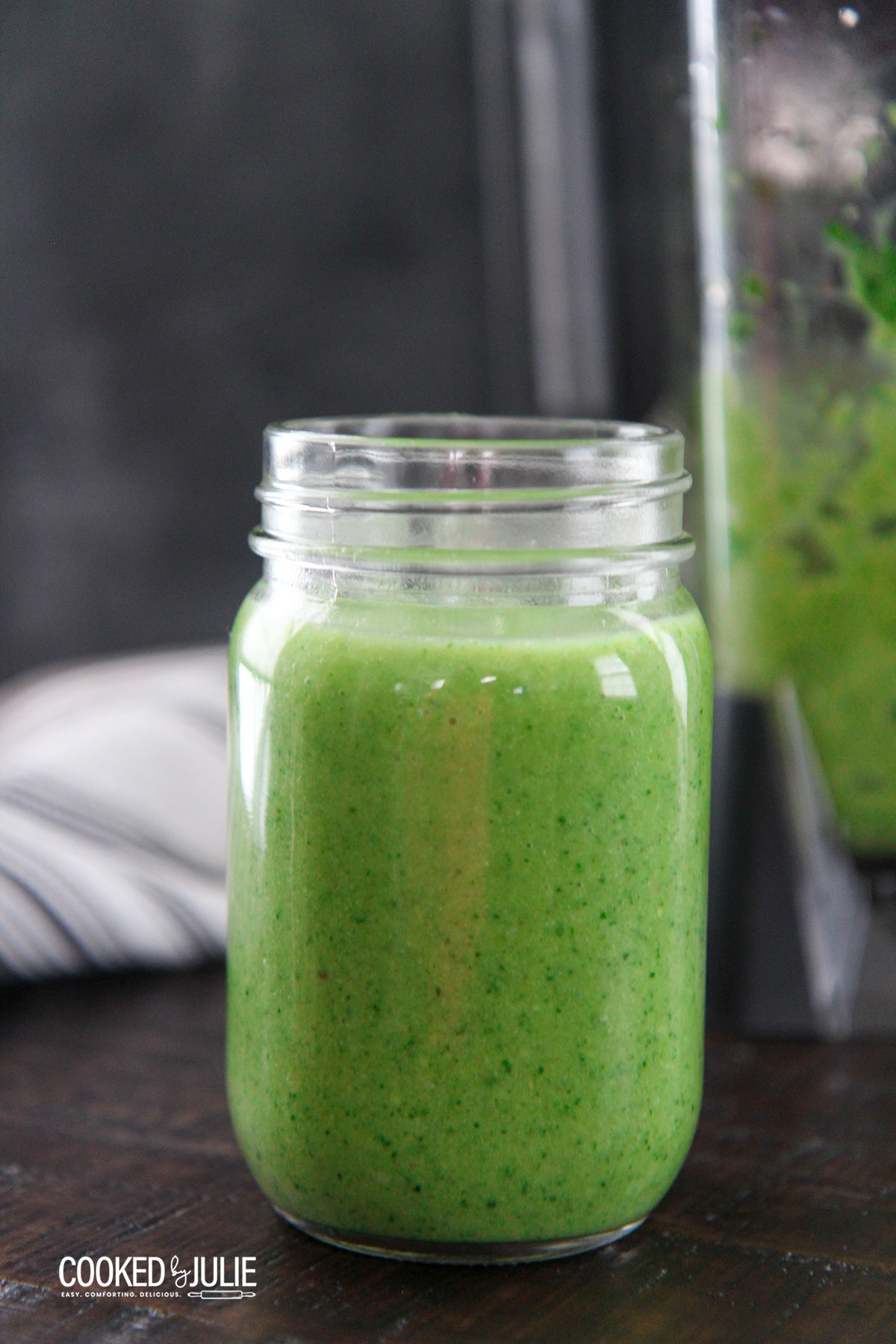 spinach avocado green smoothie in a clear mason jar 
