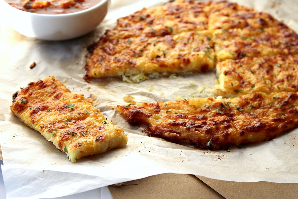 baked cheesy breadsticks with tomato sauce 