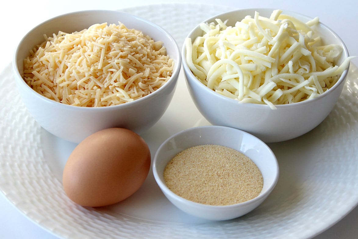 granulated garlic, cheese, and one egg on a plate 