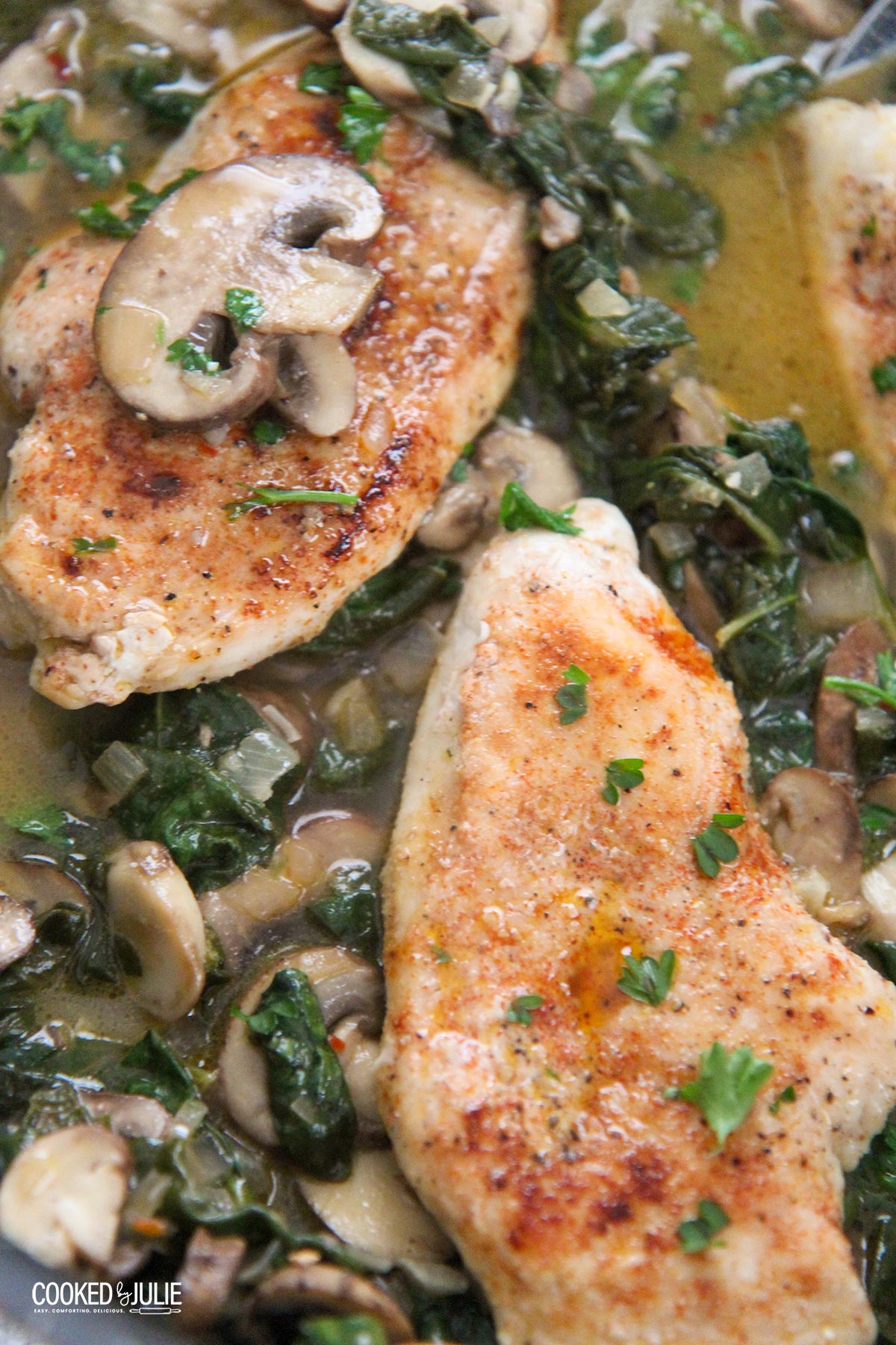 chicken, spinach, and mushroom in a skillet 