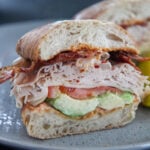 turkey bacon avocado sandwich on a gray plate