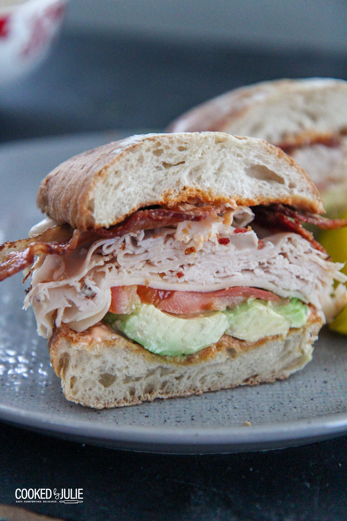 turkey bacon avocado sandwich on a gray plate