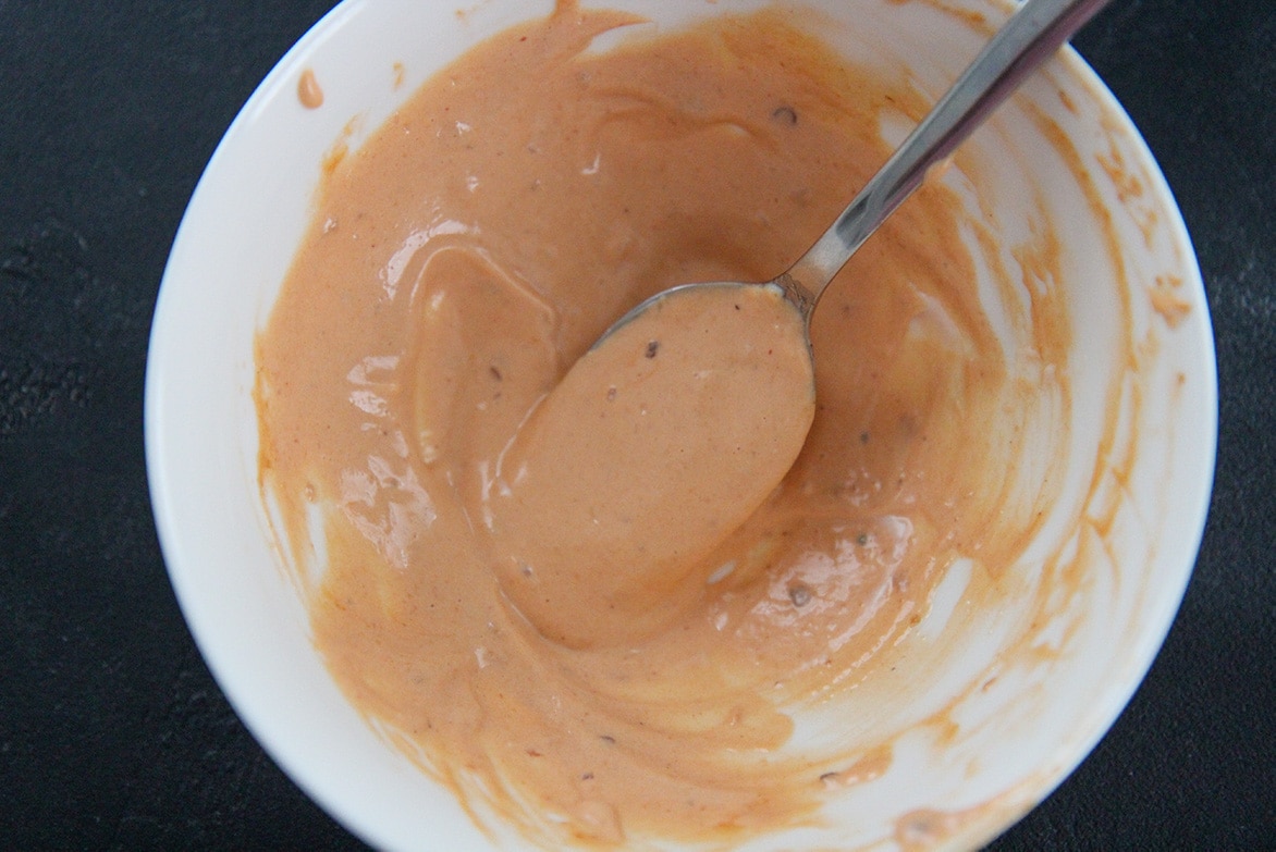 chipotle mayo sauce in a white bowl with a spoon 