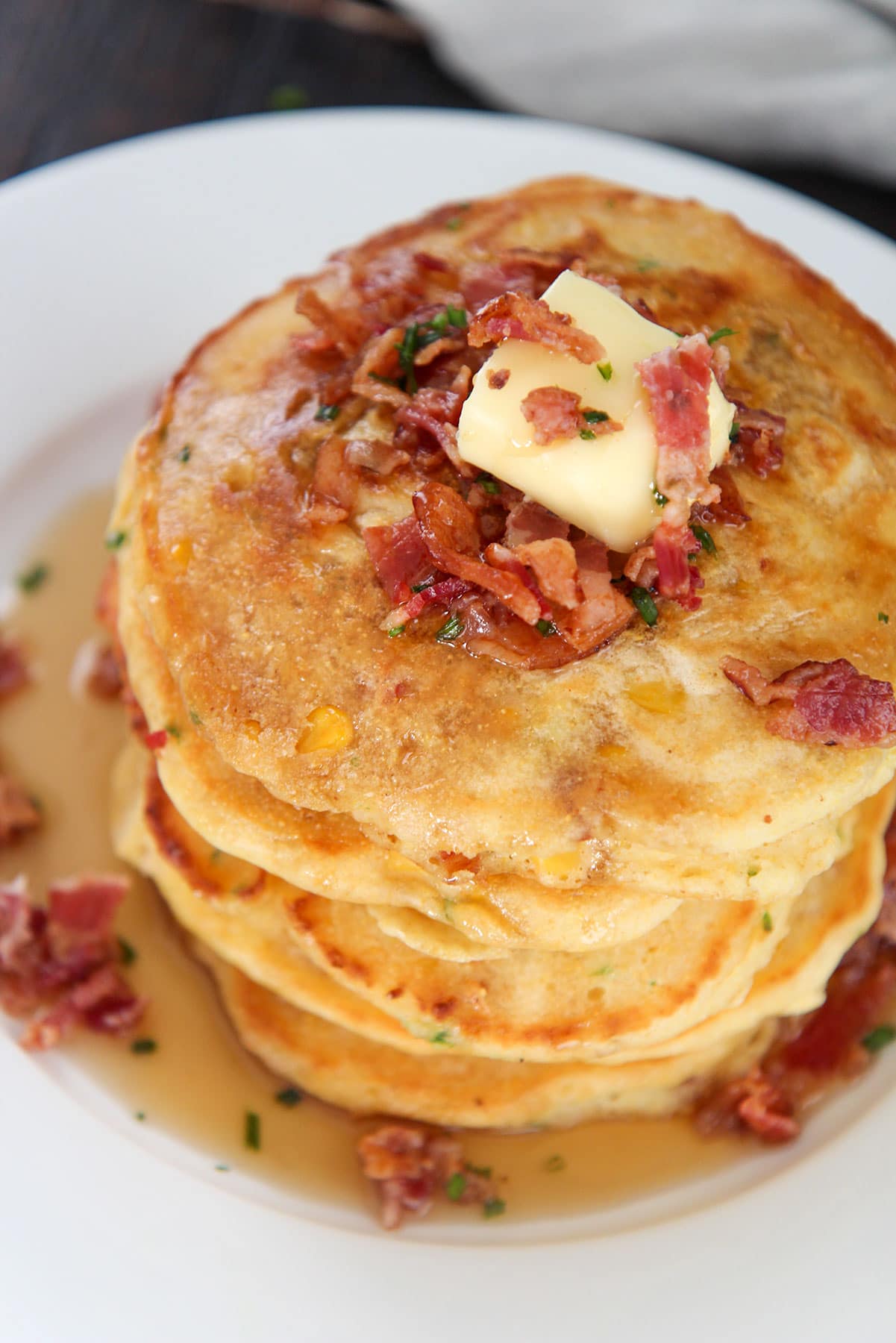 five corn cakes on a plate. 