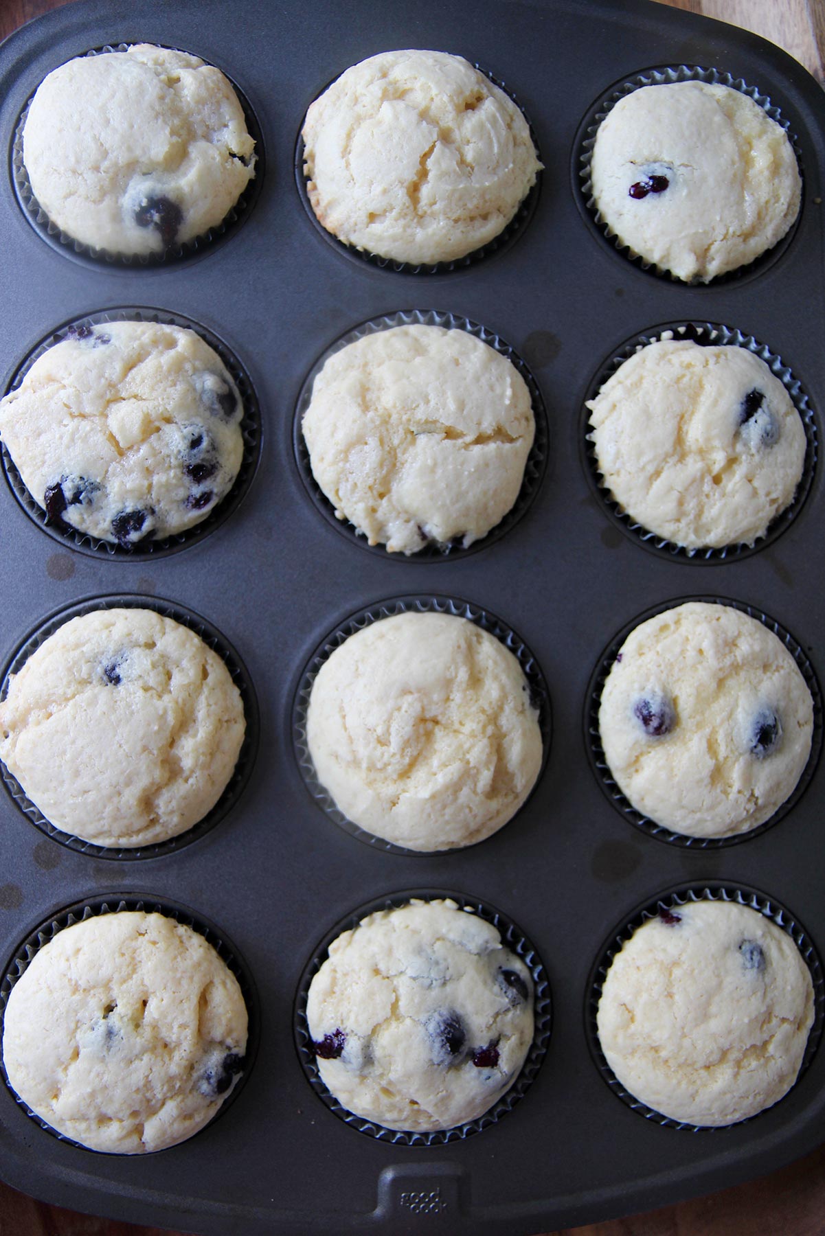 twelve baked cupcakes in a muffin tin 